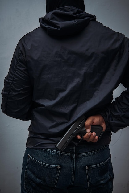 Behind the scenes Burglar or terrorist Holding a pistol in various poses on isolated background with clipping path