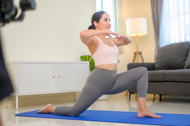 Behind the scenes of Fit young woman doing yoga and meditation at home