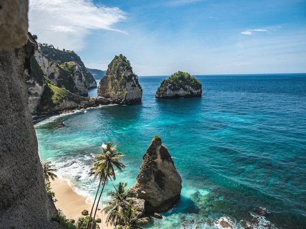 Scenic aerial view of high rocks at a white sand beach of Nusa Penida Bali Indonesia