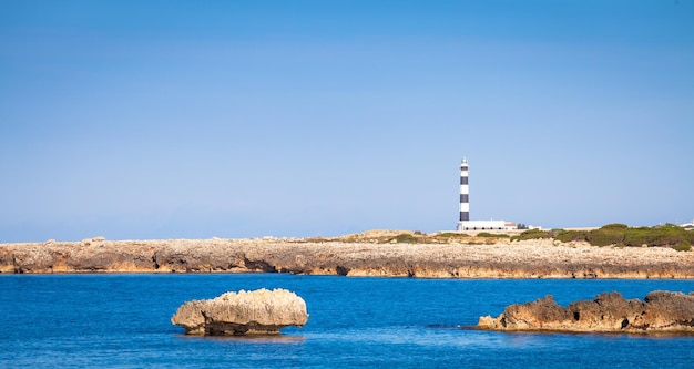 Scenic Artrutx Lighthouse at sunset in Minorca Spain