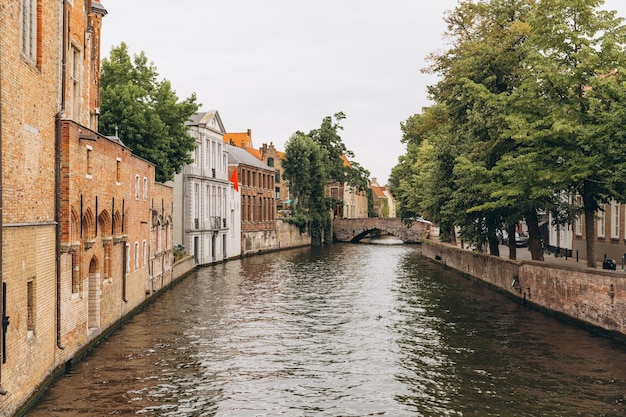 Scenic city view of Bruges canal with beautiful medieval colored houses and bridge Belgium