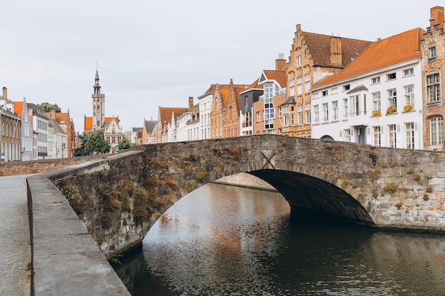 Scenic city view of Bruges canal with beautiful medieval colored houses bridge in the morning hour Belgium