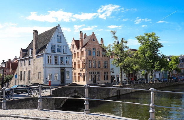 Scenic city view of Bruges canal with beautiful medieval colored houses and reflections