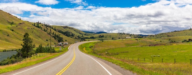 Scenic road in farm lands sunny cloudy sky okanagan british columbia canada