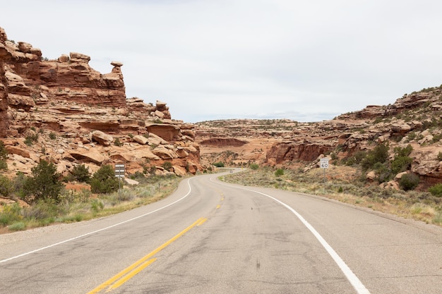 Scenic road surrounded by red rock mountains in the desert