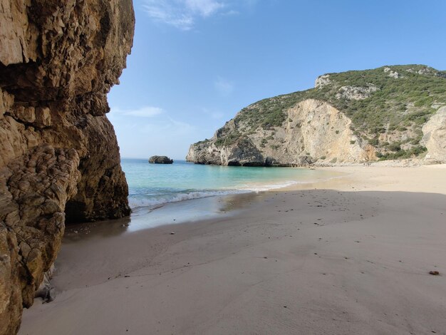 Scenic shot of cliffs on an empty beach in Sesimbra Portugal