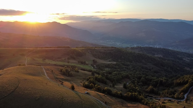 Scenic sunset over hills and beautiful nature landscape