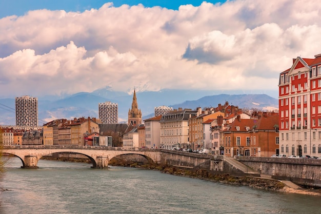 Scenic view of the banks of the isere river and bridge collegiate church of saintandre with french a