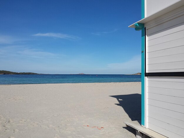 Scenic view of beach against blue sky