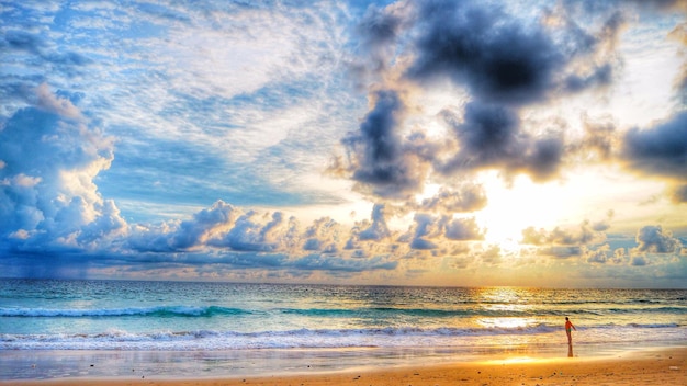 Scenic view of beach against cloudy sky