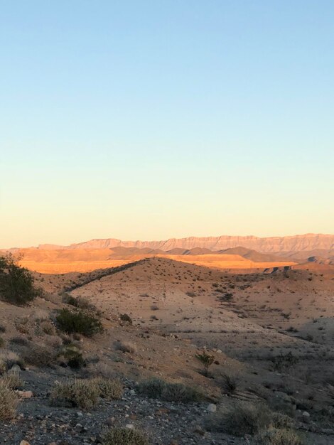 Photo scenic view of desert against sky during sunset