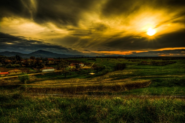 Scenic view of field against sky during sunset