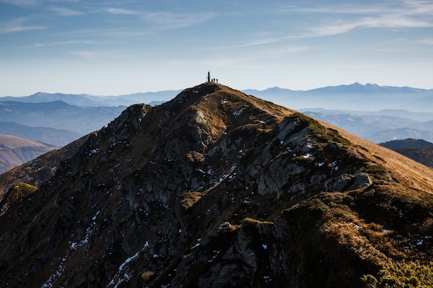 Scenic view of hikers silhouette on the top of the mountain