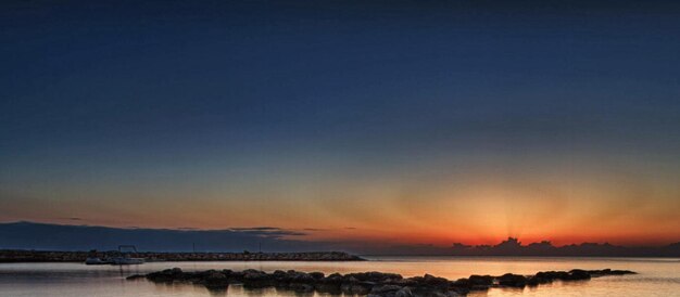 Scenic view of lake against romantic sky at sunset