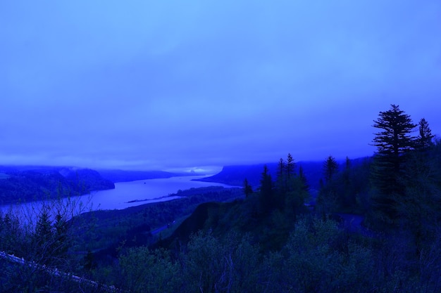 Scenic view of landscape against blue sky at dusk