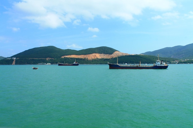 A scenic view of the mountain islands and boats near the city of Nha Trang Turquoise Sea in Vietnam