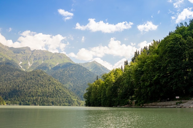 Scenic view of a mountain range and tranquil lake under a cloudy sky on a sunny dayvacation travel s