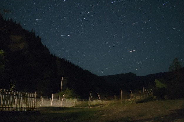 Scenic view of mountains against star field at night