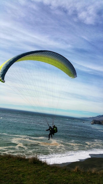 Scenic view of paraglidier against sea and sky