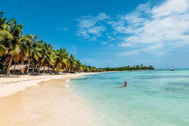 Scenic view of people on beach against sky