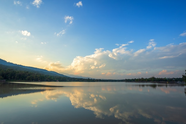 Scenic view of the reservoir Huay Tueng Tao with Mountain range forest at evening sunset