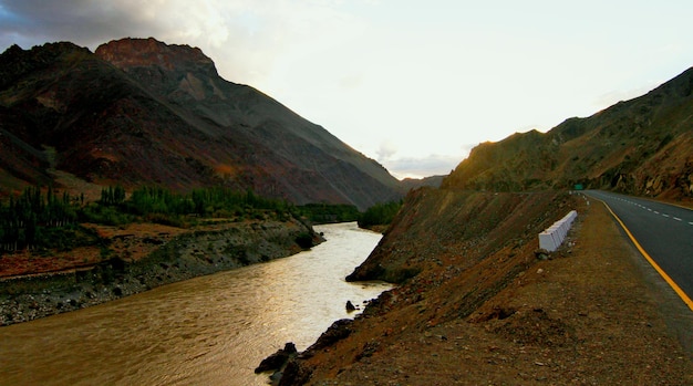 Scenic view of river and mountains against sky