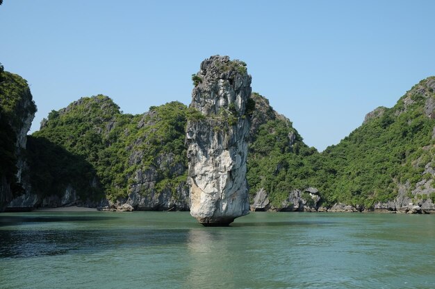 Photo scenic view of rocks in sea against clear sky