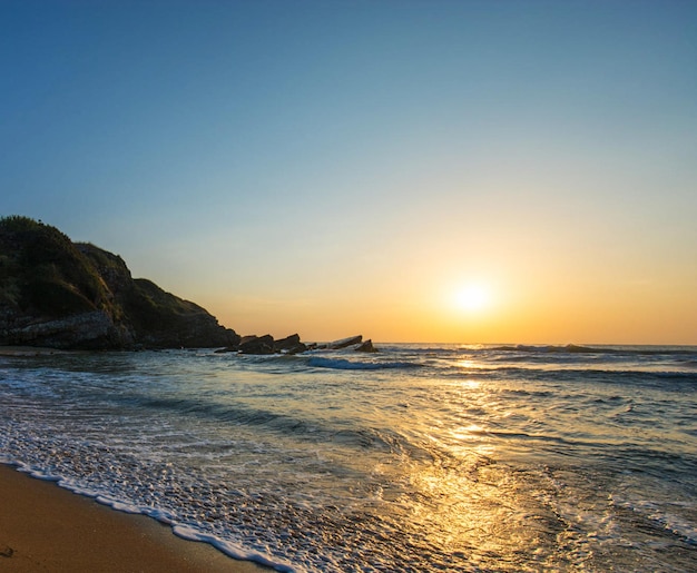 Scenic view of sea against clear sky during sunset