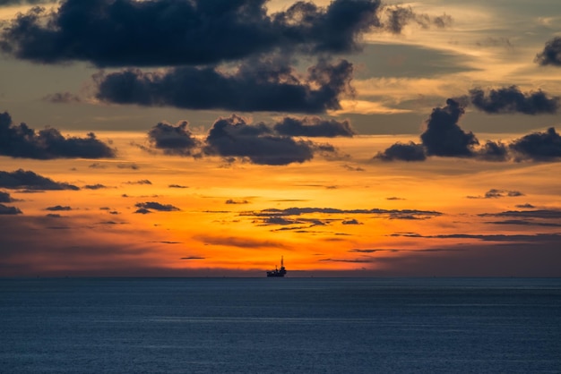 Scenic view of sea against cloudy sky during sunset