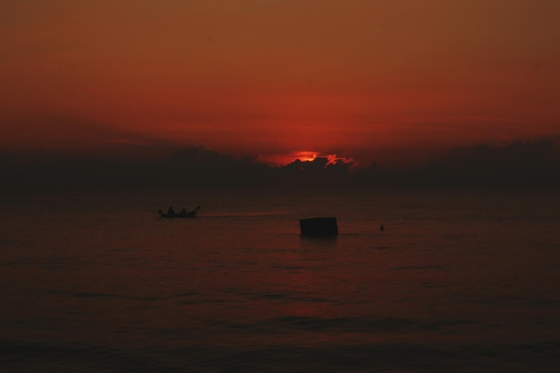 Scenic view of sea against orange sky