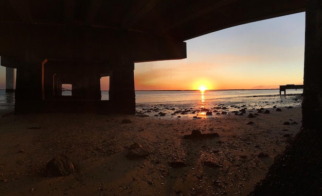 Photo scenic view of sea against sky during sunset