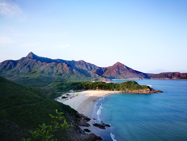 Scenic view of sea and mountains against sky