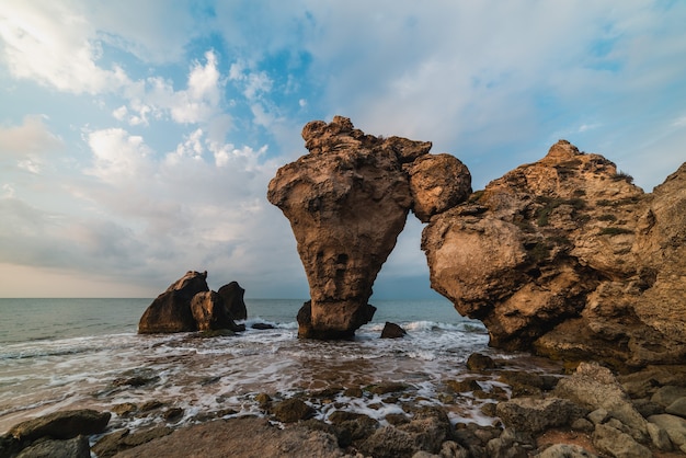 Scenic view of the sea, rocky coastline and sandy beach, outdoor travel background