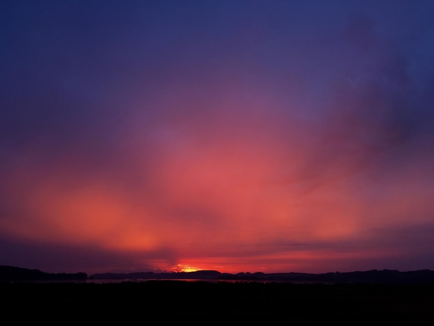 Scenic view of silhouette landscape against sky at sunset