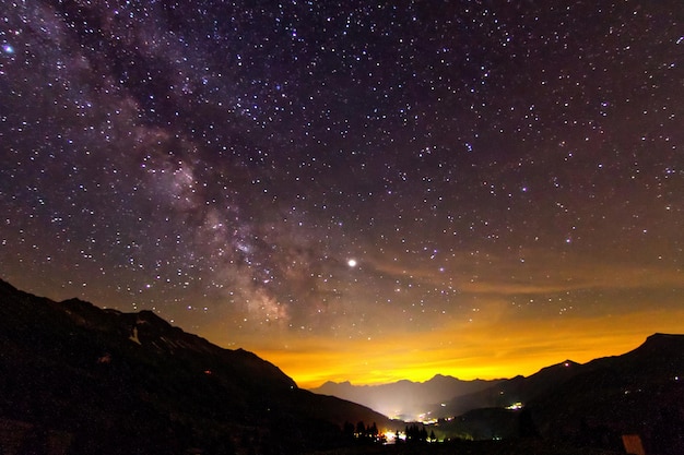 Scenic view of silhouette mountains against sky at night