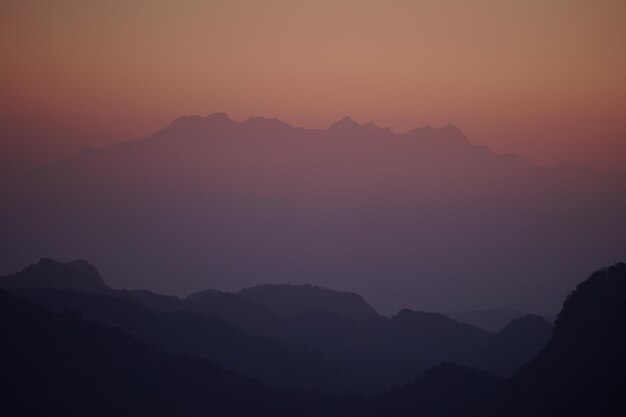 Scenic view of silhouette mountains against sky at sunset