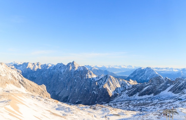 Scenic view of snowcapped mountains against blue sky