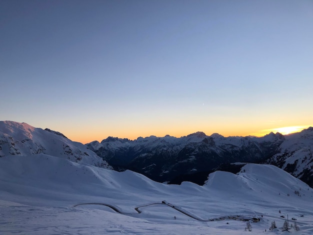 Scenic view of snowcapped mountains against clear sky during winter