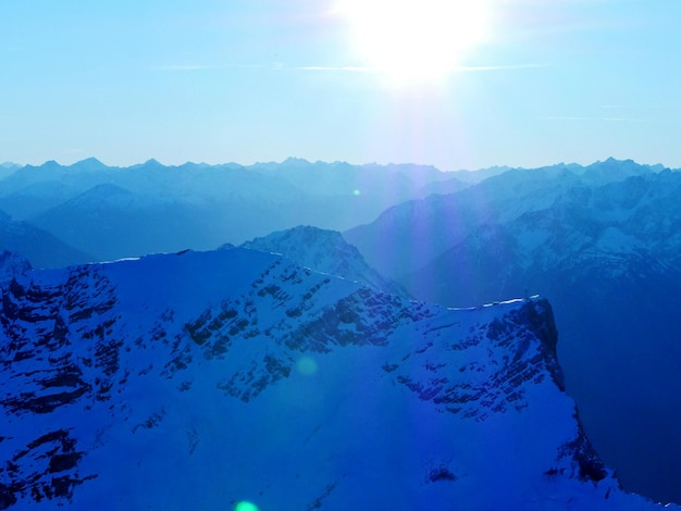 Scenic view of snowcapped mountains against clear sky