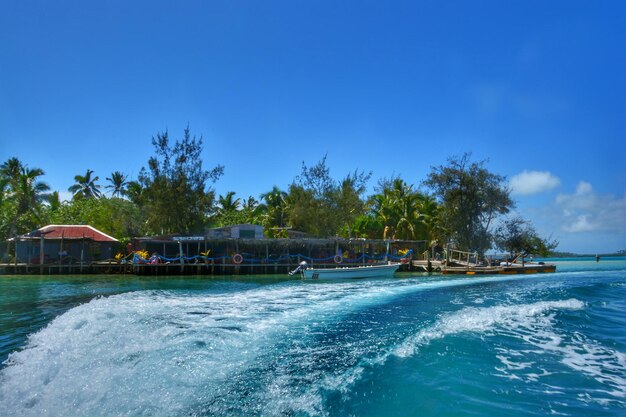 Scenic view of swimming pool by sea against blue sky