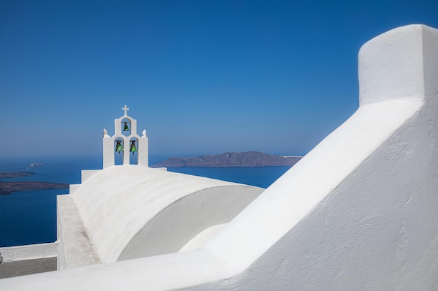 Scenic view of traditional cycladic white houses and blue domes in Oia village, Santorini island