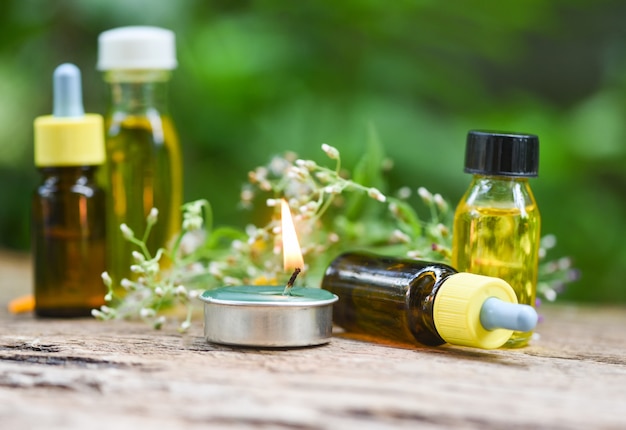 Photo scented candles and essential oils on wooden table