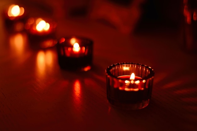 Scented candles in glass candlesticks in a room in the evening. Romantic atmosphere.