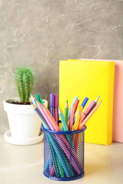 Photo school accessories concept photo of stationery on grey background vertical photo