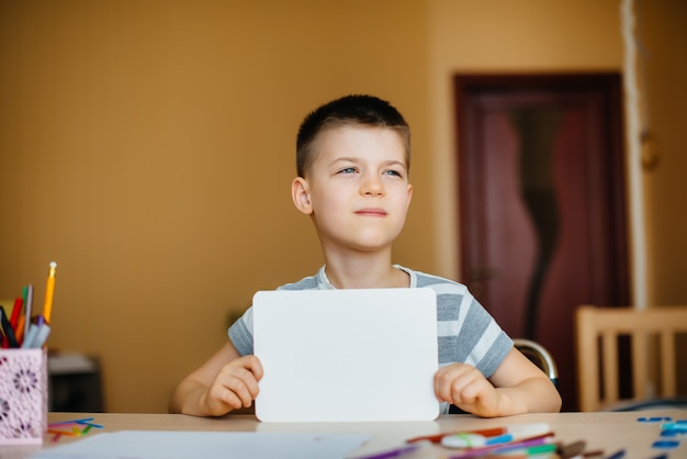 school-age boy does homework at home. Training at school