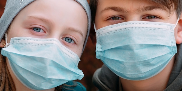 School-age children in medical masks. portrait of school children.