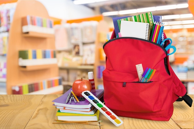 School Backpack with stationery on  background