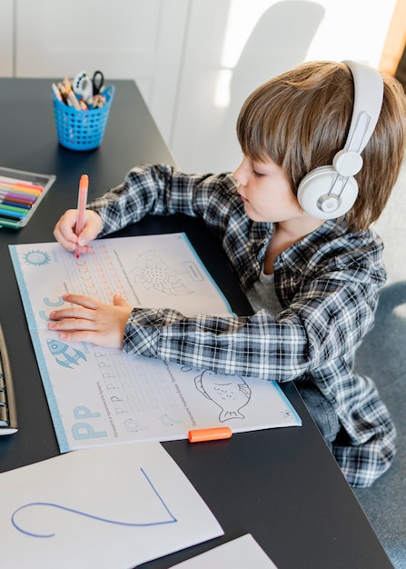 School boy taking online courses high view