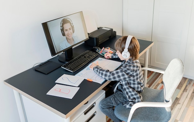 School boy taking online courses long shot