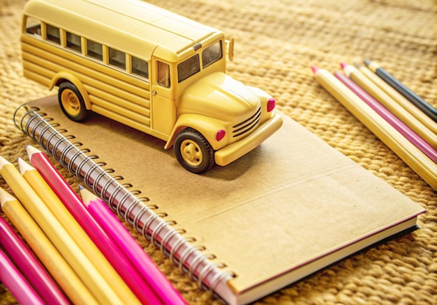 a school bus is on a table with pencils and pencils